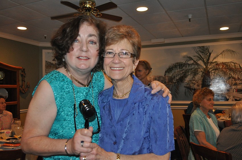 Outgoing Longboat Library President Amy Roth, right, passed the gavel to Patrice Greene at an April 14 luncheon at The Lazy Lobster.