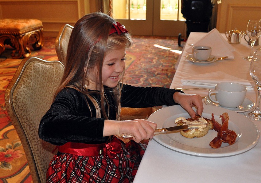 Tiffany McCoy, 7, butters her mitten-shaped French toast.