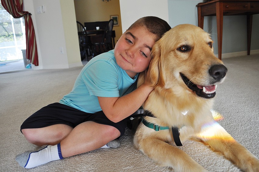 Grayson Tullio, 8, welcomed home his own service dog, Hooch, May 18. Grayson suffers from Duchenne muscular dystrophy.Published May 31, 2012.