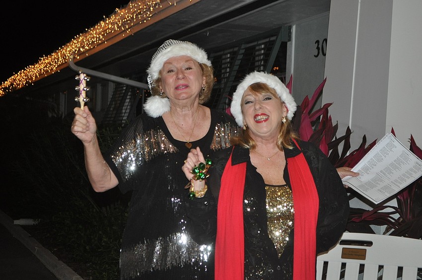 Mellonie Smicklas and Lisa Hall greeted guests with Christmas carols.