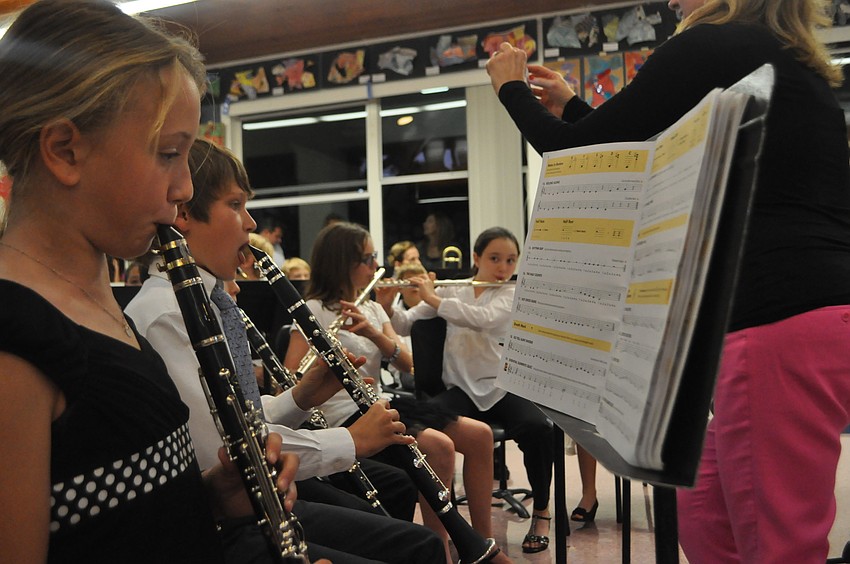 Jane Scheirber reads her music and practices before the performance.