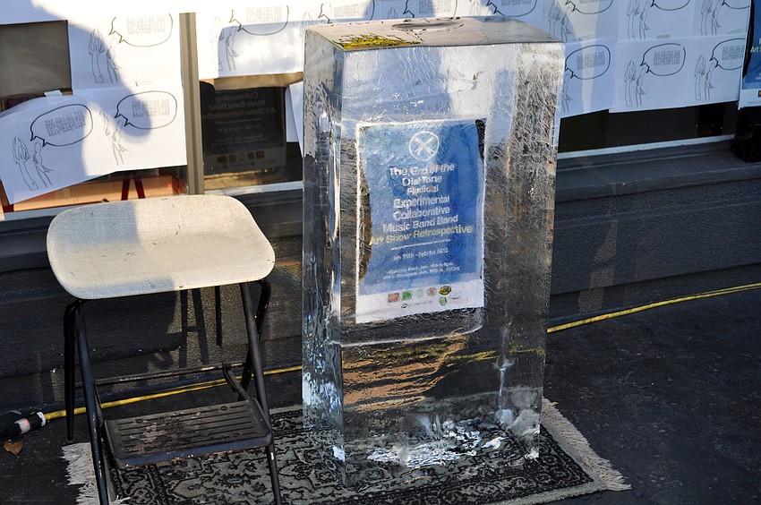 A poster for the event sits frozen inside a block of ice.
