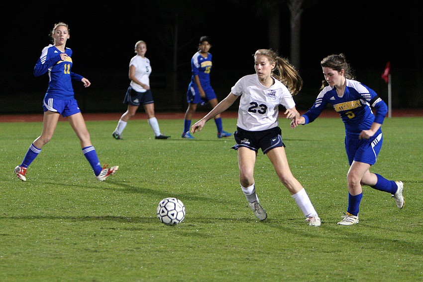 Out-of-Door Academyâ€™s Annika Lange, No. 23, and Canterburyâ€™s Whitney Laurent, No. 6, go after the ball.
