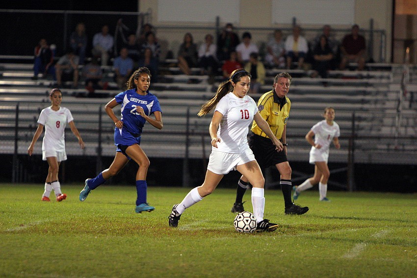 Cardinal Mooneyâ€™s Jill Polk, No. 10, runs up the field with the ball.