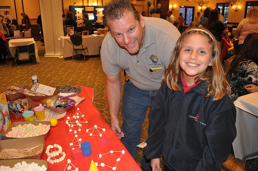Scott and Elena Wood classified 3-dimensional shapes at the Manatee Charter School table.