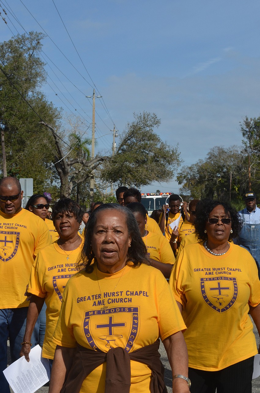 Eartha Phelps marches with her church members down Dr. Martin Luther King Way.