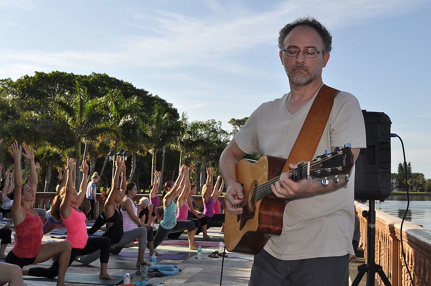 Randall Buskirk plays live music throughout the yoga class.