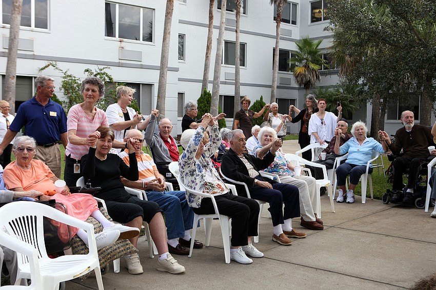 Residents sing and hold hands while doing the â€œsitting Torahâ€.