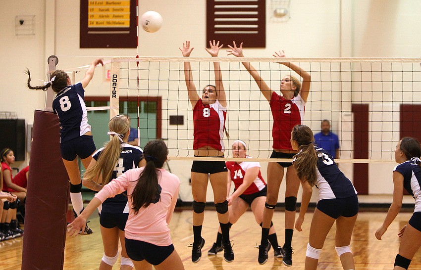 The Out-of-Door Academyâ€™s Lauren Maxey, No. 8, spikes the ball over the net as Cardinal Mooneyâ€™s Maria Soscia, No. 8, and Gabby Schweigart, No. 2, attempt to hit the ball back over the net.