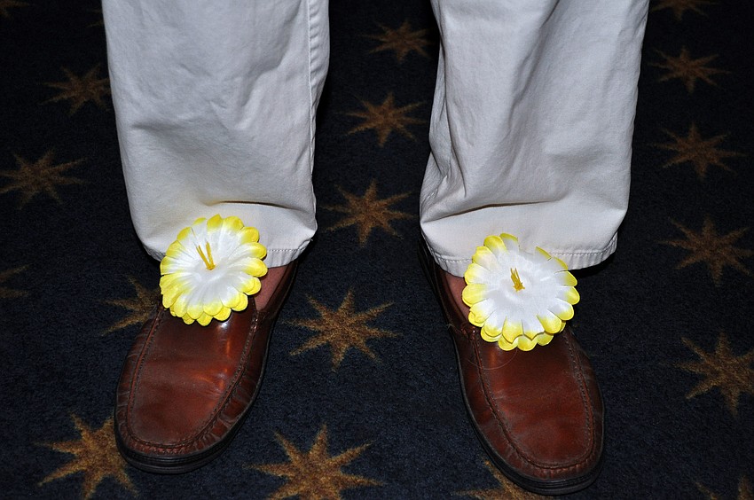 Bill Lloyd decorated his shoes with fake flowers for Bird Key Yacht Clubâ€™s luau Saturday, Sept. 22.