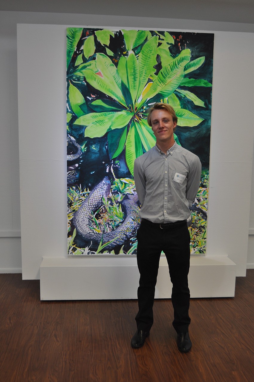 Dustin Jungel in front of his work