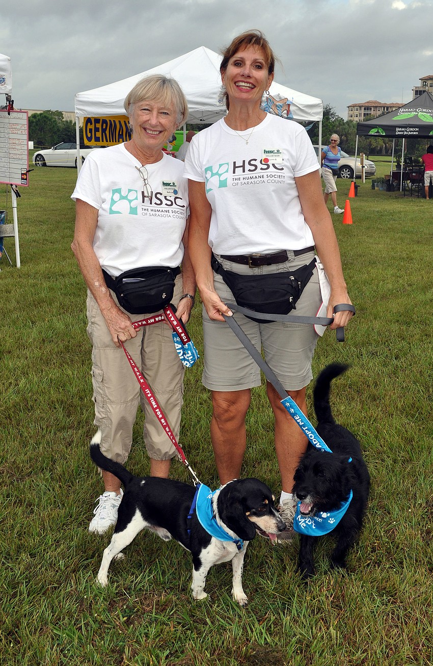 Humane Society volunteers Beth Macaulay with Ramsey, 6, and Lynn Billi with Sparky, 4, had fun wandering the market Wednesday, Oct. 3.