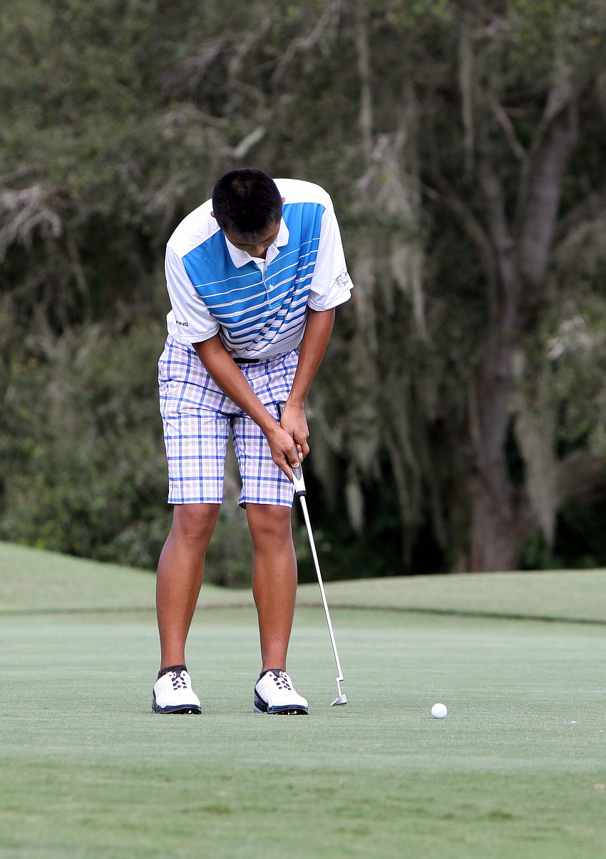 Ken Shi, 17, of Sarasota Christian, putts his ball towards the hole during the golf match Tuesday, Oct. 9, at Bent Tree County Club.