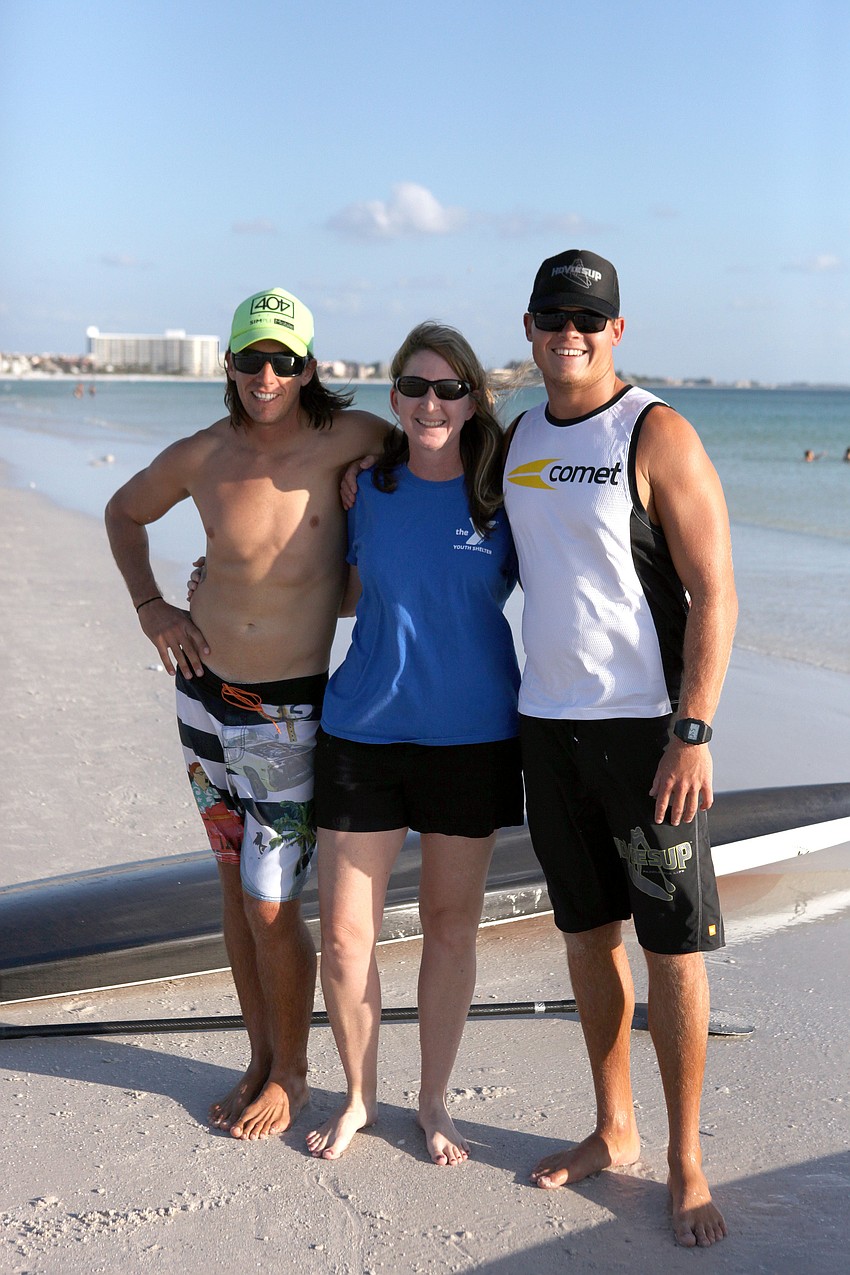 Robert Martini and Brad Ward pose with the director of the Y Youth Shelter, Nickie Hartsock.
