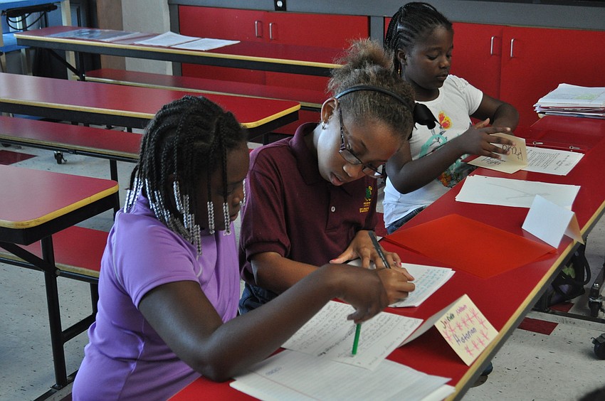 Jabrielle Nelson and Shaniya Lane review their notes.