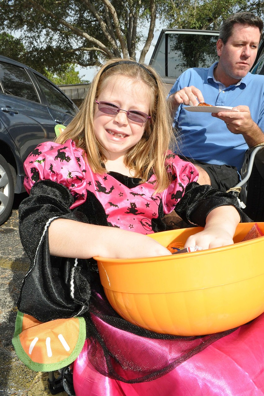 Hannah Van Hise, 7, held off on her pizza dinner so she could keep passing out candy.