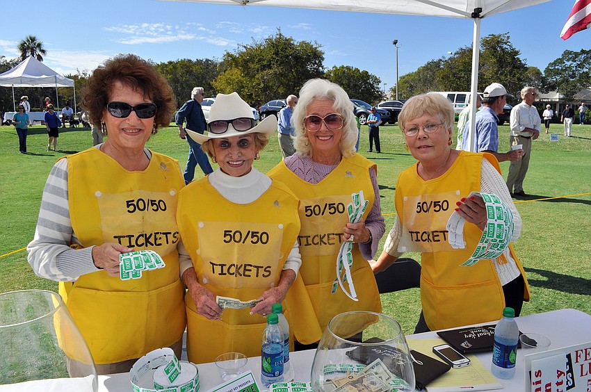Gosette Whiteneck, Edith Barr Dunn, Susan Randall and Norah Browne pose together in their bright yellow 50/50 raffle outfits.