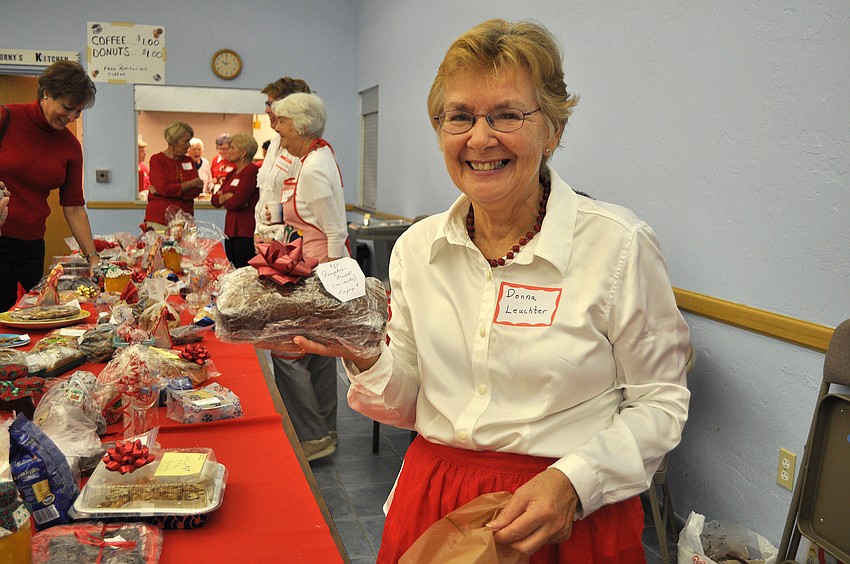 Donna Leuchter holds up some pumpkin bread she sold Saturday, Nov. 17, at St. Mary Star of the Seaâ€™s Holiday Bazaar.