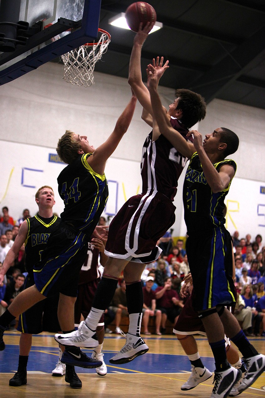Riverviewâ€™s Nick Havener, No. 25, shoot sthe ball while Sarasota Christianâ€™s Lance Helmuth, No. 44, and Emmanuel Lambright, No. 21, attempt to block him.