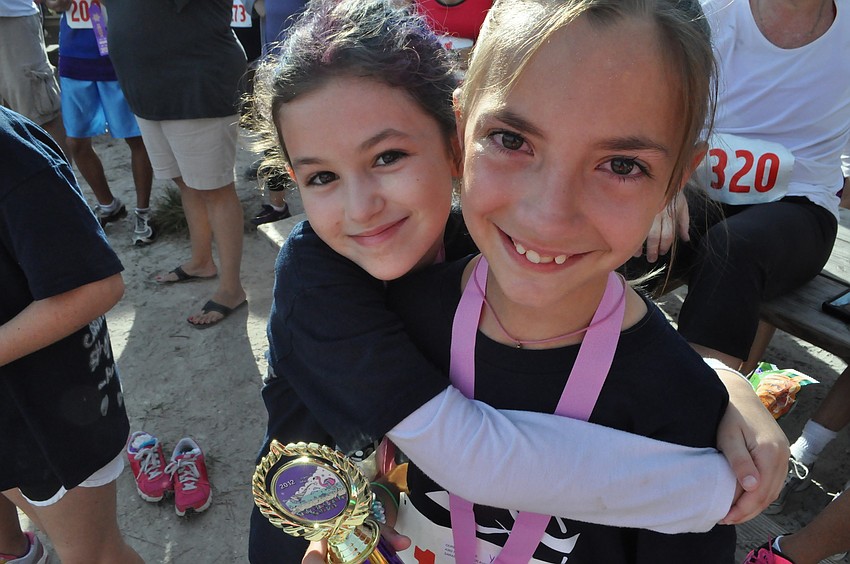 Rylie Oâ€™Fallon congratulates her friend Grace Ourednik who received 1st place in her one to nine year age group.