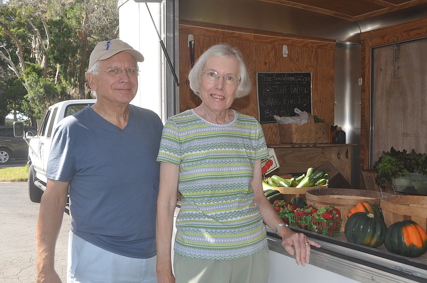 Chet and Linda Pletzke purchase some strawberries, eggplant and tomatoes from Parrish-based True Family Farmâ€™s mobile stand.