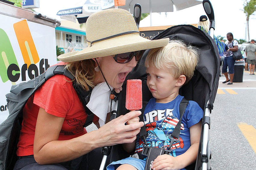Asher Boyett, 3, reluctantly shared his Pop Craft popsicle with his mom, Kate at Siesta Key for the 34th Annual Siesta Fiesta April 14 and 15.