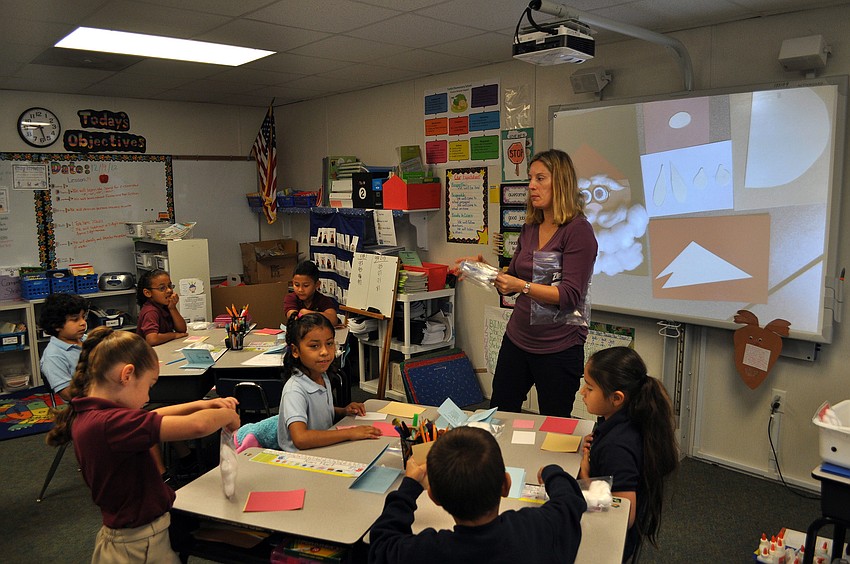 Mrs. Melissa Thompson gives instructions to her students on how to make a Santa Christmas card Friday, Dec. 14. Mrs. Thompsonâ€™s class was learning about how people in England celebrate Christmas by sending elaborate Christmas cards.
