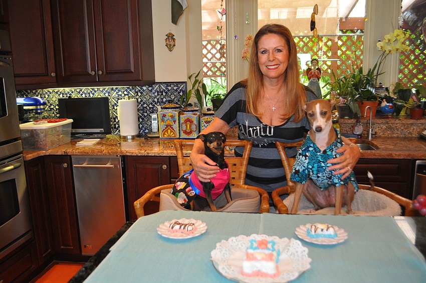 B.B., left, and Shadow, right, posed with their owner, Shannon Gault, who launched Pupcake Pooch Parties this fall. The online company brings canines and humans together for all sorts of celebrations.