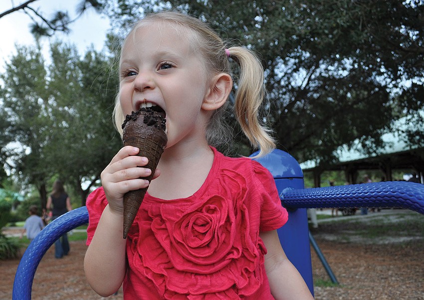 Madeline Gersh, 3, was more excited about eating her ice cream than playing, during Temple Emanu-El's annual family picnic Aug. 25. Published Sept. 6, 2012.