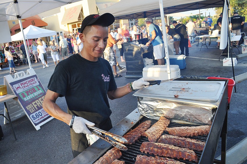 Luis de Jesus, of Pincherâ€™s Crab Shack, prepares ribs for the crowd, during the Barbecue Cook-off on Lakewood Ranch Main Street Sept. 29. Published Oct. 4, 2012.