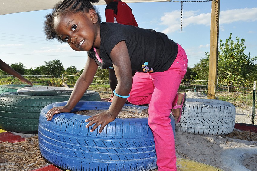 Courtney Harris plays on a tire, during Mixon Fruit Farms' annual Harvest Festival Nov. 16-18. Published Nov. 29, 2012.