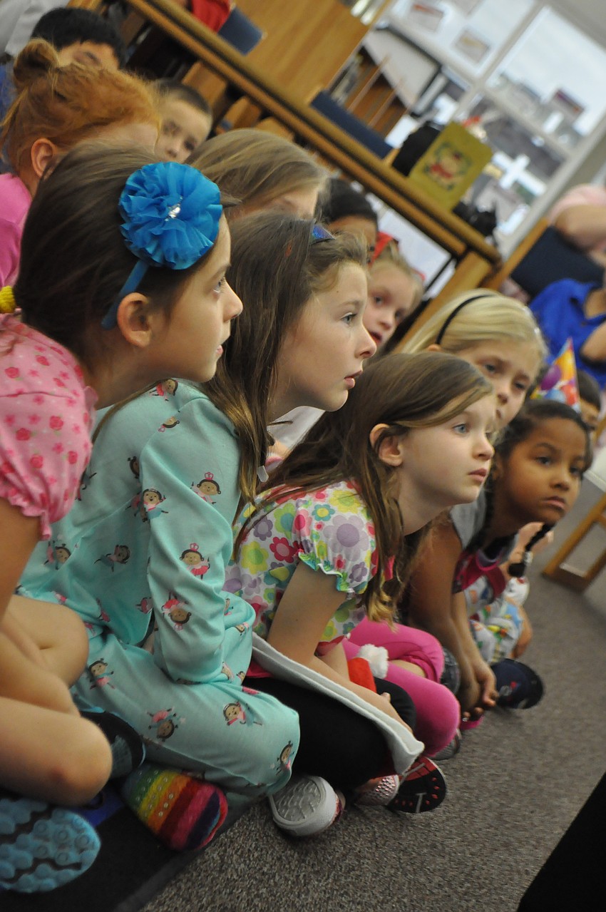Children listen to the story.