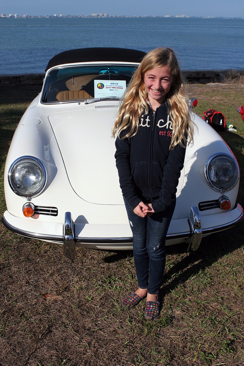 Jacqueline Hennecke, 10, poses in front of her parents Porsche.