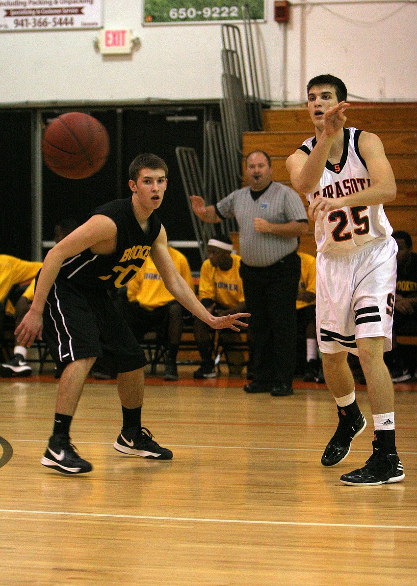 Booker High Schoolâ€™s Mark Misja, No. 30, watches as Sarasota High Schoolâ€™s Jake LeBlanc, No. 25, pass the ball cross court.