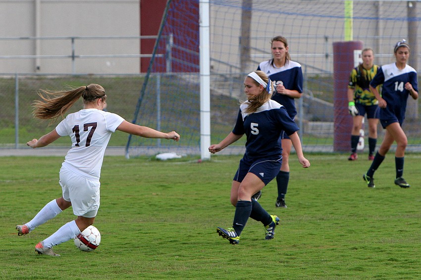 Riverviewâ€™s Katy Mixon, No. 17, heads towards the goal while North Portâ€™s Jenna Staub, No. 5, tries to block her Saturday, Jan. 12, at Riverview High School.