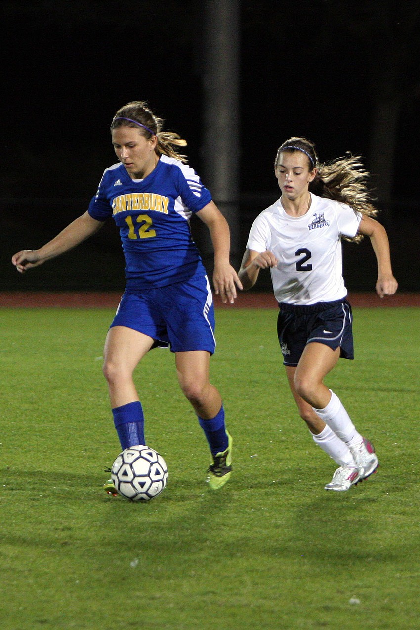 Canterburyâ€™s Paige Liebel, No. 12, tries to keep the ball away from Out-of-Door Academyâ€™s Kimmy Comito, No. 2.