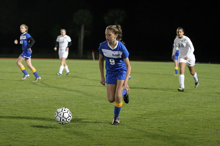 Sarasota Christianâ€™s Taylor Smith, No. 9, runs the ball up the field.