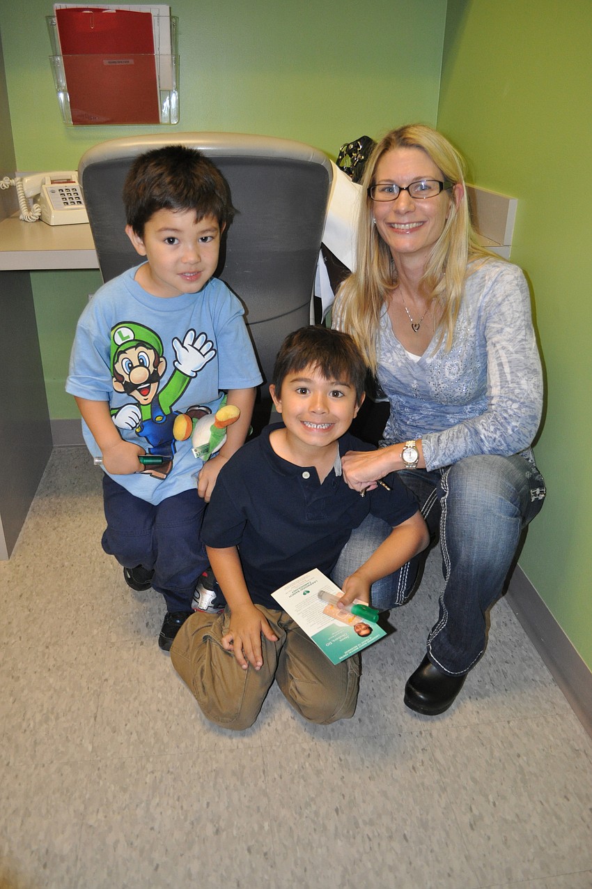 Sheryl Okuhara with her sons Carter (left) and Evan