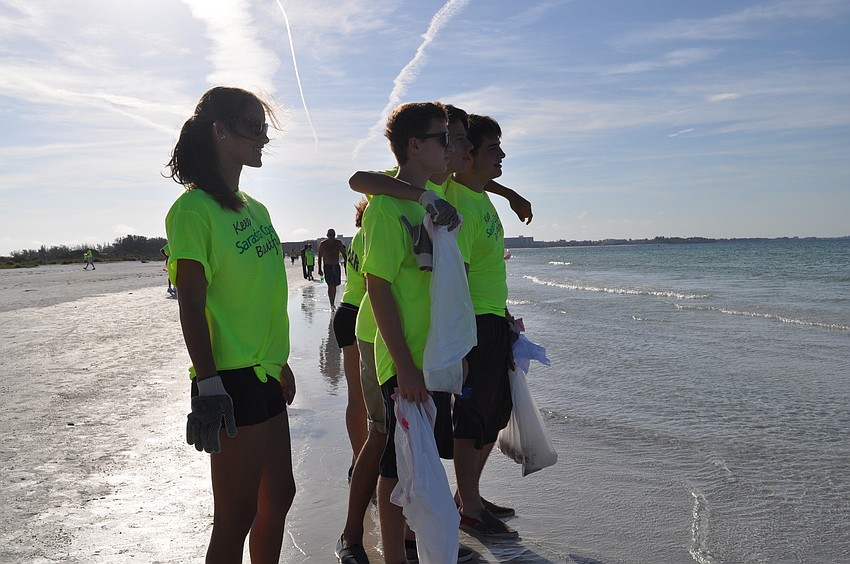 A group of Riverview High School Students stops to watch a herd of manatees mating in shallow Siesta Key waters.