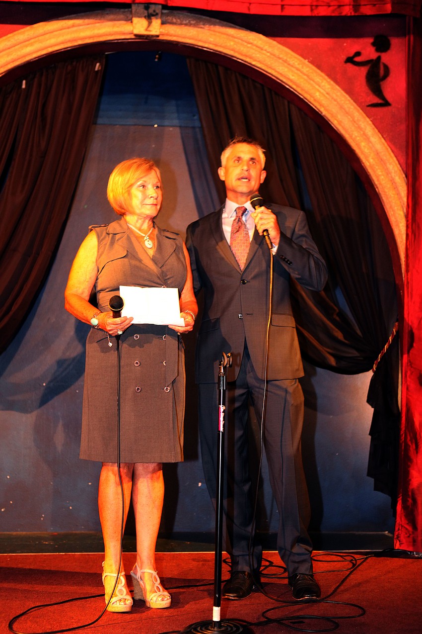 Judy Holderness and her son, Mike Holderness, Jr., talk to the crowd about the importance of early detection. Holderness was the highest going bachelor last year bringing in $1700.