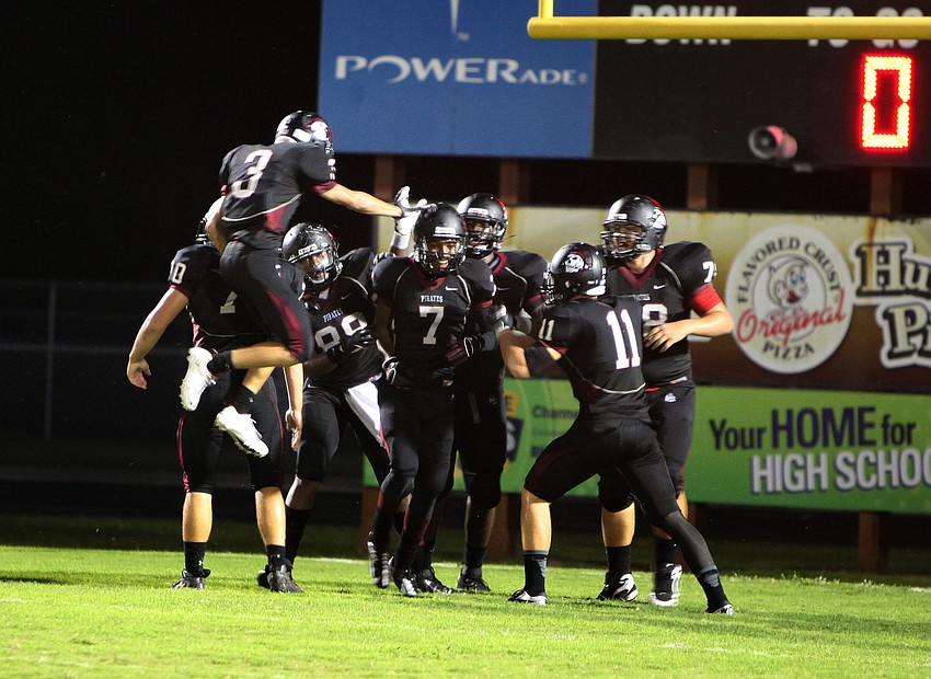 Justin Ross, No. 7, gets congratulated by his teammate after making a touchdown Friday, Sept. 21 during the Braden River versus Riverview game at Braden River.