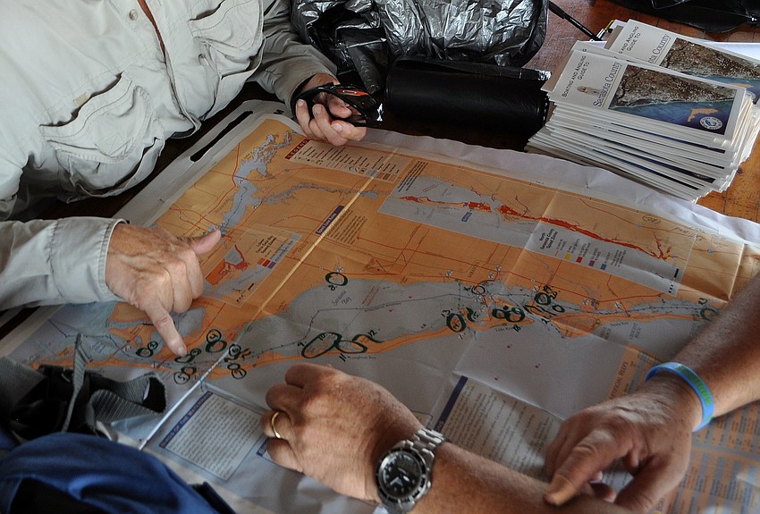 Kayakers and boaters try to figure out where people should head out to Saturday, Sept. 29 during the third annual Sarasota Bay Watch monofilament clean up.