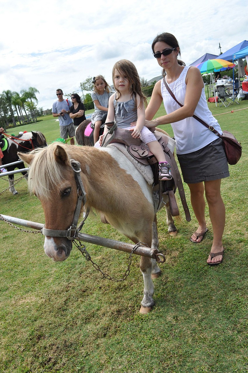 Aubrey Hamilton, 2, took her first pony ride with the help of her mom, Melissa.
