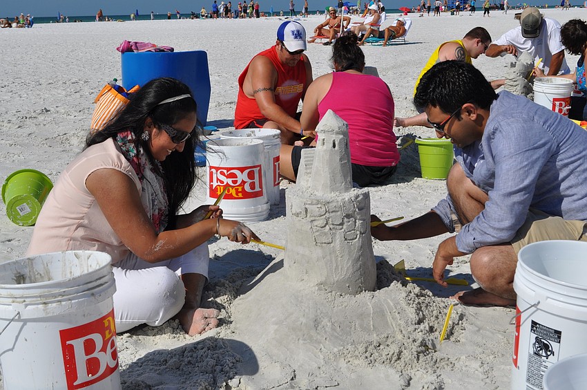 Navreet Kaur and Mohit Gupta add texture to their sand castle.