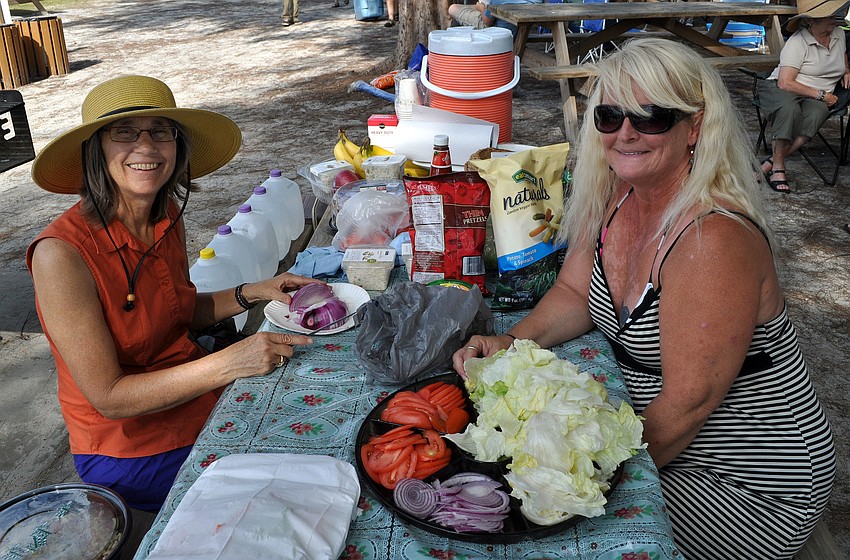 Julie Morris and Libby Hershberger get food ready for the beach bash potluck Sunday, Oct. 14.