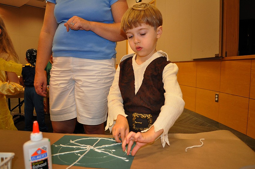 Mason Peters, 4, works on his spider web in his pirate costume.