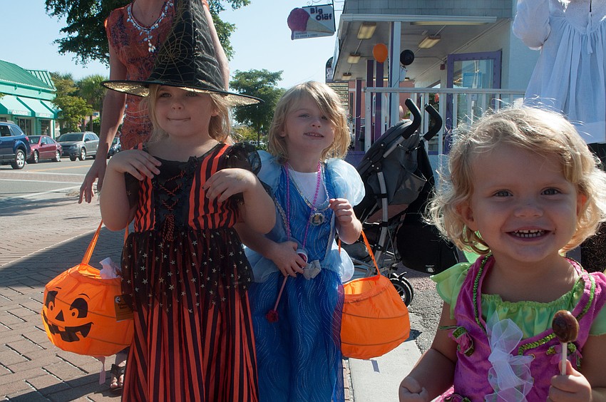 Lindsey and Danny Pfirrman trick-o-treat with Victoria Maypole.