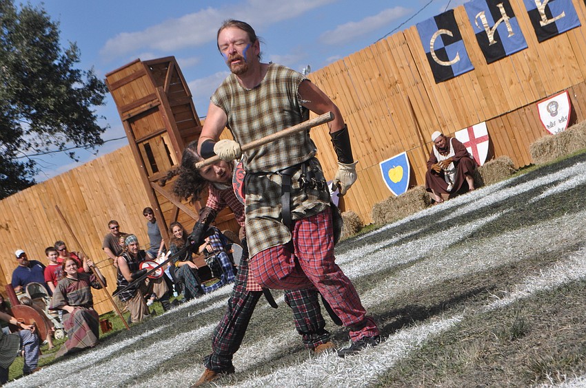 Human chess pieces fight during the match.