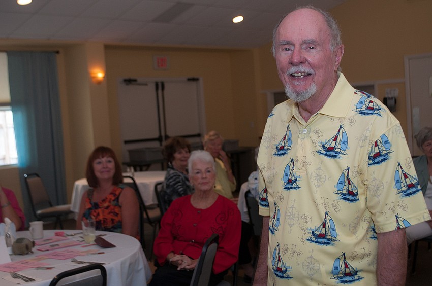 Charlie Lenny models a yellow sailboat shirt.