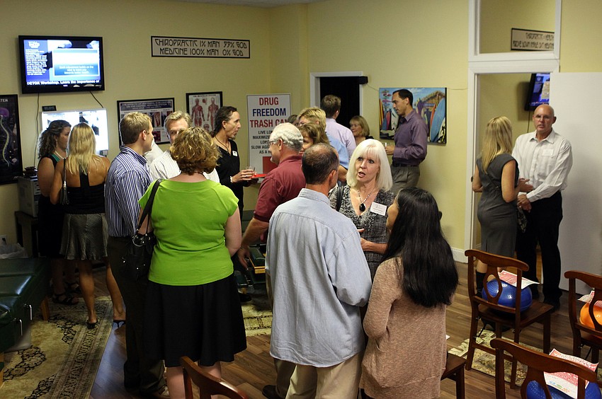 People mingle with one another at the Siesta Key Chamber of Commerce Business Card Exchange event Thursday, Nov. 15, at the Amazing Life Chiropractic.